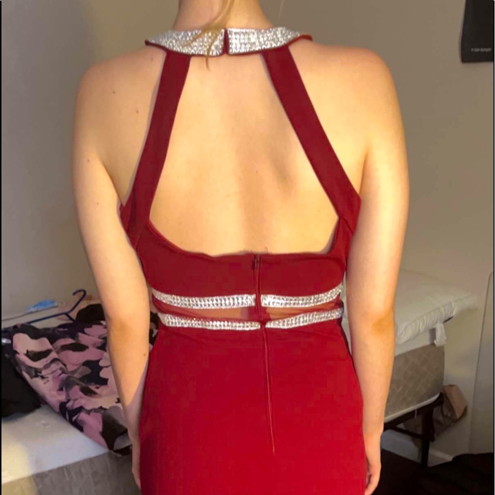 Red halter top floor length ball gown with slit down middle and silver detailing